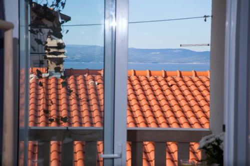 a view of a tile roof from a window at Villa Makarana Apartments in Makarska