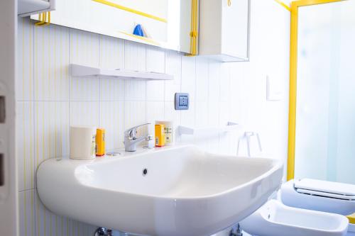 a bathroom with a white sink and a toilet at Amarcord casa vacanze in Alberobello