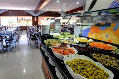 
a buffet filled with lots of different types of food at Apartamentos Marina d'Or Beach 2ª Linea in Oropesa del Mar
