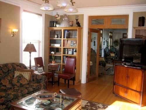 a living room with a couch and a table at Lilac Inn in Brandon
