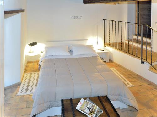 a bedroom with a bed with a magazine on a table at Agriturismo La Peonia in Bagnoregio