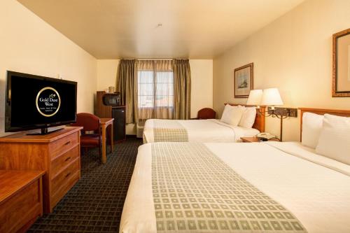 a hotel room with two beds and a flat screen tv at Gold Dust West in Carson City