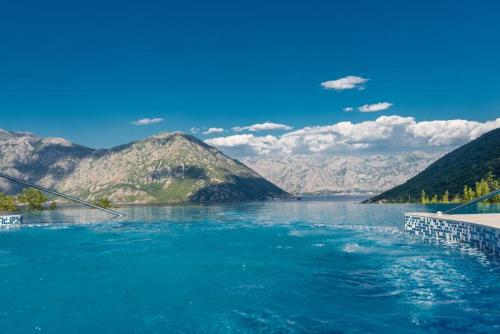 a view of a river with mountains in the background at Lavender Bay Apartment C12 in Donji Morinj
