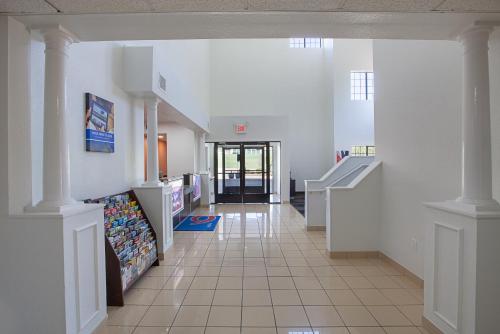 a hallway of a hospital with a couch and stairs at Motel 6-Bedford, TX - Fort Worth in Bedford