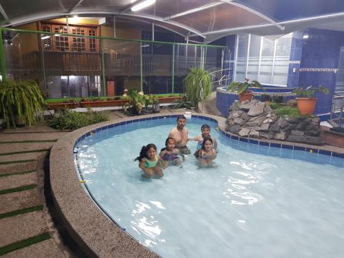 a group of people in a swimming pool at Fuentes del Volcán in Baños