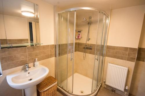 a bathroom with a shower and a sink at Fryatt Hotel & Bar in Harwich