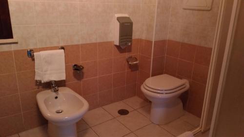 a bathroom with a toilet and a bidet at Hotel La Falconara in Castrovillari