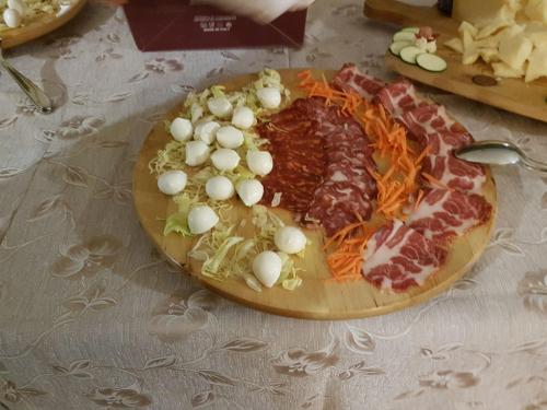 a plate of food with meat and vegetables on a table at Hotel La Falconara in Castrovillari