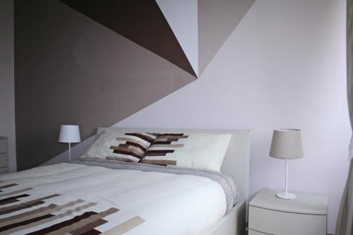 a bedroom with a bed with a geometric headboard at La Casa di Giulia in Caserta