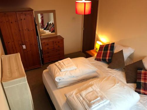 a bedroom with two beds with towels on them at Flat 9a Badby Close in Manchester