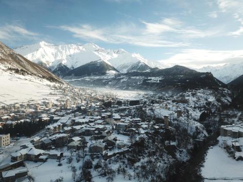an aerial view of a city with snow covered mountains at Hotel Svanseti in Mestia