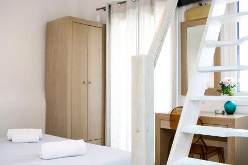 a bedroom with a ladder and a bunk bed at Niriides Homes & Villas in Elia Beach