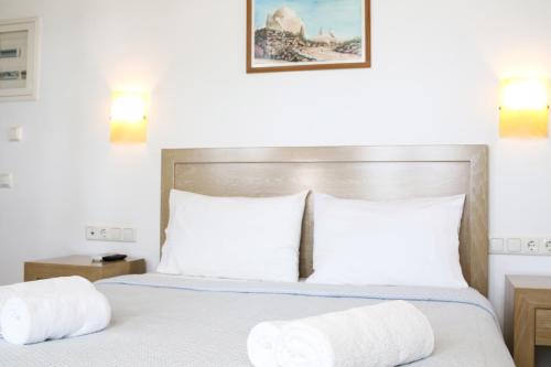 a bedroom with a bed with two pillows at Niriides Homes & Villas in Elia Beach