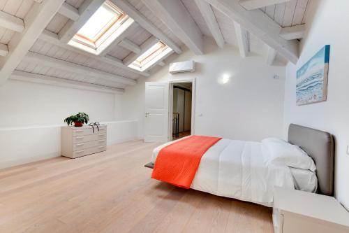 a bedroom with white walls and a large bed at Residence La Fontaine in Venice-Lido