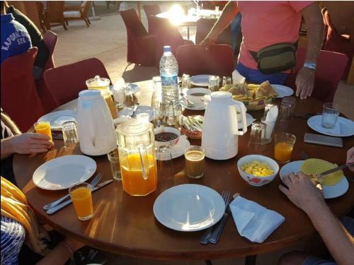 a group of people sitting around a table with food at Terres d'Amanar in Tahannout