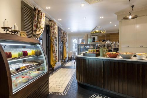 a restaurant with a counter with food on display at Sofitel Queenstown Hotel & Spa in Queenstown