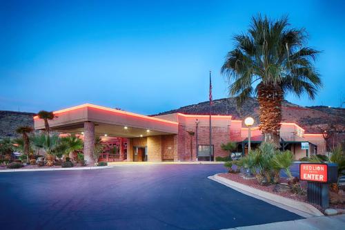 a hotel with a palm tree in front of a building at Red Lion Hotel and Conference Center St. George in St. George