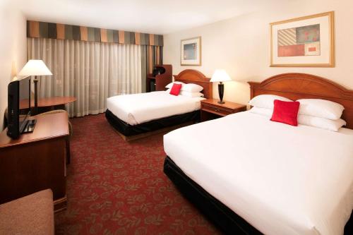 a hotel room with two beds and a television at Red Lion Hotel and Conference Center St. George in St. George