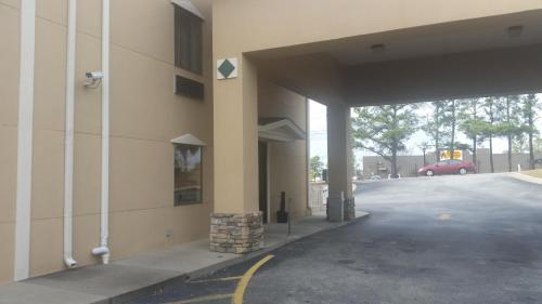 an empty parking lot next to a building at Baymont by Wyndham Grovetown Augusta in Augusta