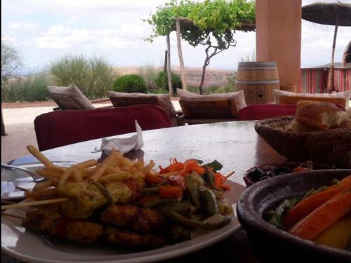 a plate of food on a table with french fries at Terres d'Amanar in Tahannout