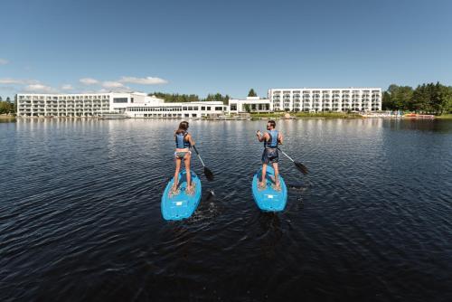 two people on paddle boards in the water at Estérel Resort in Esterel
