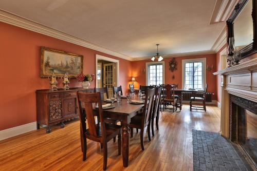a dining room with a table and chairs and a fireplace at Stone Chalet Bed & Breakfast Inn in Ann Arbor