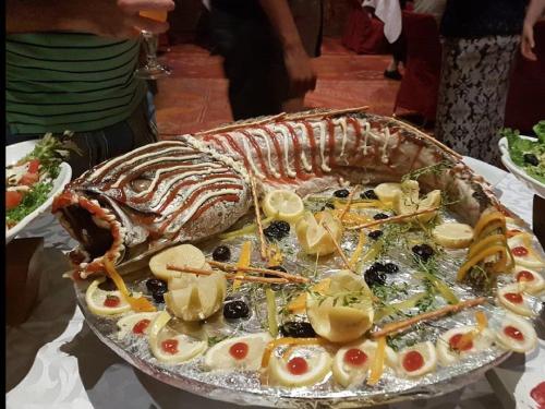 a large platter of food with a lobster on it at Terres d'Amanar in Tahannout