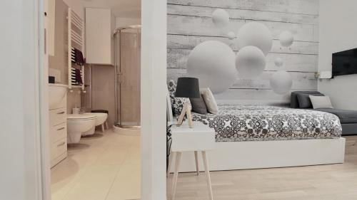 a white bedroom with a bed and a bathroom at P&D Apartments Navigli Ripa Ticinese in Milan