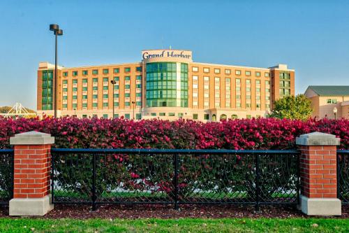 a building with a fence in front of a field of flowers at Grand Harbor Resort and Waterpark in Dubuque