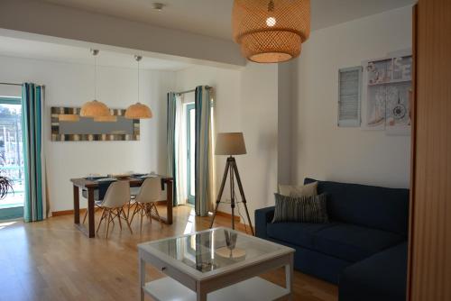 a living room with a blue couch and a table at Beautiful Apartment In Albufeira Marina in Albufeira