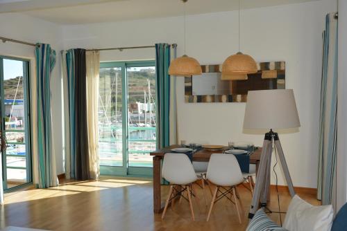 a dining room with a table with chairs and a lamp at Beautiful Apartment In Albufeira Marina in Albufeira