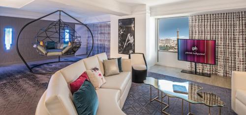 a living room with a couch and a tv at Planet Hollywood Resort & Casino in Las Vegas