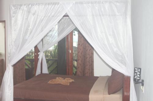 A bed or beds in a room at Rock Pool Homestay