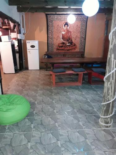 a room with a table and a painting on the wall at Hostel del Barranco in La Pedrera