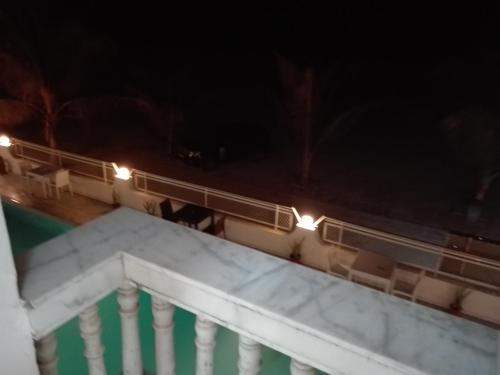 a view of a pool at night with lights at Salalah Beach Villas in Salalah