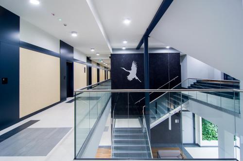 a staircase in a building with a bird on the wall at Hotel Barczyzna Medical Spa in Nekla
