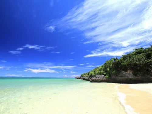 a beach with an island in the ocean at Seven Colors Ishigakijima in Ishigaki Island