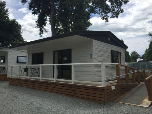 a mobile home with a porch and a deck at Geraldine TOP 10 Holiday Park in Geraldine