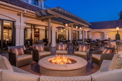 an outdoor patio with chairs and a fire pit at Hyatt Regency Westlake in Westlake Village