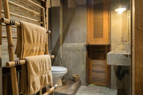 a bathroom with a toilet and a sink at The Flying Fish Hostel in Dumaguete