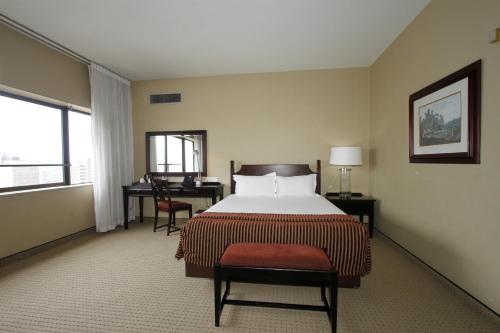 a hotel room with a bed and a desk at The Royal Hotel by Coastlands Hotels & Resorts in Durban