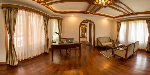 a living room with a table and a laptop on a desk at Park Village Resort by KGH Group in Kathmandu