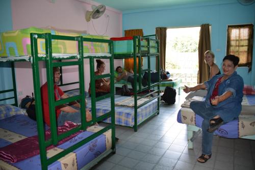 a group of people in a room with bunk beds at Jay Guesthouse and Restaurant (adult only) in Chiang Mai