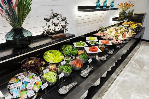 a buffet line with many different types of food at Dedeman Cizre Hotel in Jesıret ibn Omar