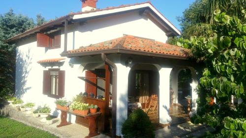 a small white house with a roof at Apartment Slavi in Vipava