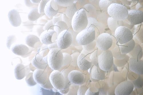 a bunch of white balls hanging from a wall at Hotel Cubo in Ljubljana