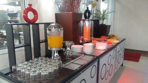 a counter with a drink mixer and plates and cups at Lavendish Hills Kandy in Kandy