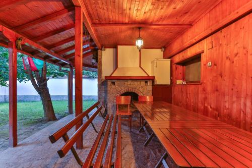a dining room with a table and a fireplace at Guest House Villa Teres in Shipka