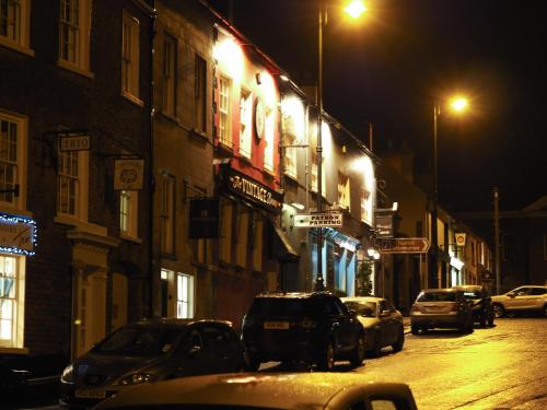 a city street at night with cars parked at No.33 Coach House in Hillsborough