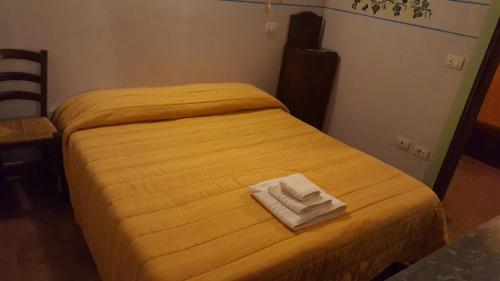 Ένα ή περισσότερα κρεβάτια σε δωμάτιο στο Agriturismo La.Ti.Mi.Da.